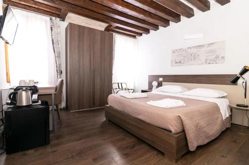 a bedroom with a bed and a television in it at Il Pozzo Magico in Venice