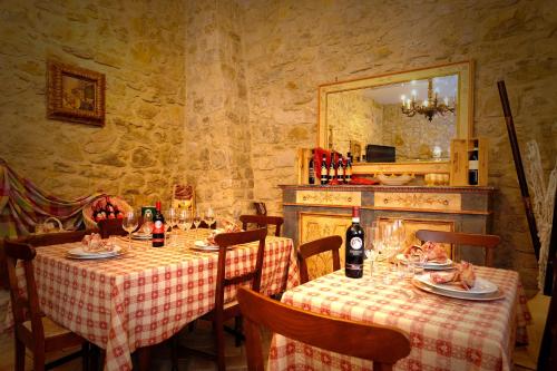 a dining room with two tables and a mirror at Agriturismo Casa Brunori in Foligno