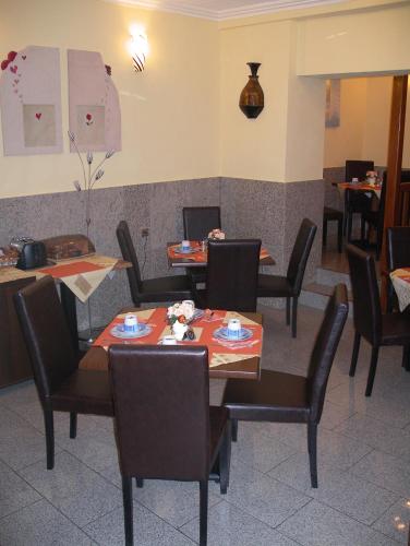 a restaurant dining room with tables and chairs at Hotel Elbe Street 34 in Frankfurt/Main