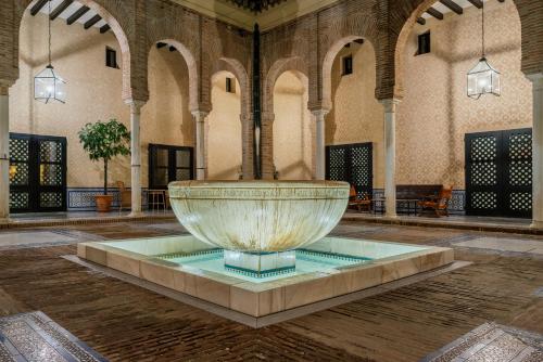 a large fountain in the middle of a building at Parador de Carmona in Carmona