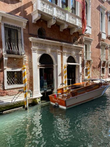 a boat in the water in front of a building at Ruzzini Palace Hotel in Venice
