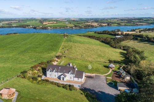 an aerial view of a large house on a green field at Four Winds,Kinsale Town,Exquisite holiday homes,sleeps 26 in Kinsale