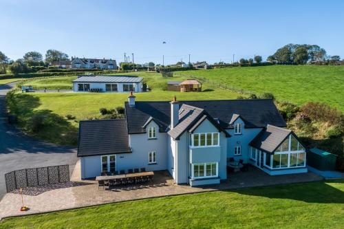 an aerial view of a house in a field at Four Winds,Kinsale Town,Exquisite holiday homes,sleeps 26 in Kinsale
