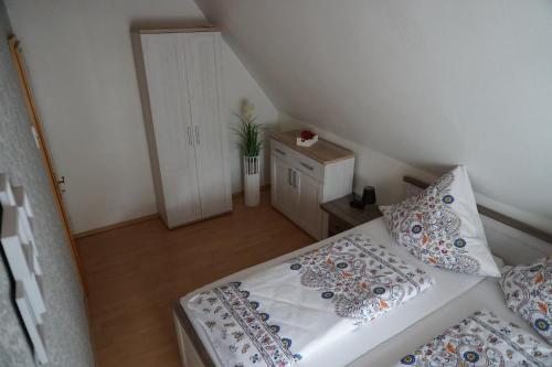 a small bedroom with a bed with pillows on it at Ferienwohnung Waldblick in Bad Wildungen