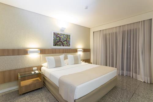 a hotel room with two beds and two lamps at Mar Hotel Conventions in Recife