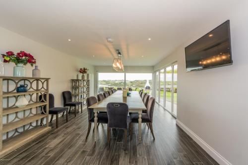 a dining room with a long table and chairs at Marina views, Kinsale, Hosted by Exquisite holiday homes, sleeps 20 in Kinsale