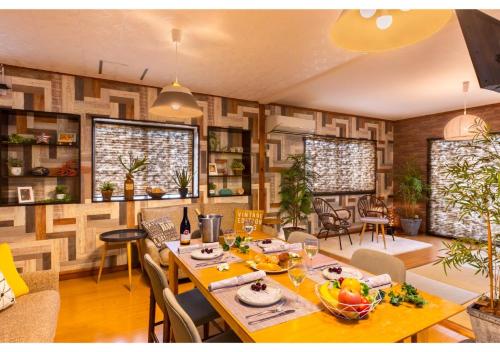 a dining room with a table with fruits on it at Residential Hotel 183 Naha in Naha