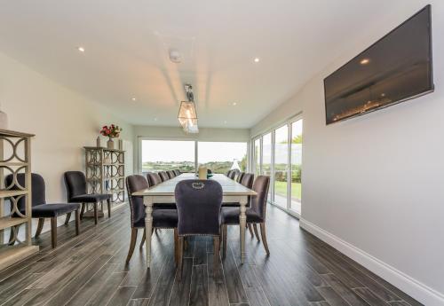 a dining room with a table and chairs at Marina views, Kinsale, Hosted by Exquisite holiday homes, sleeps 20 in Kinsale