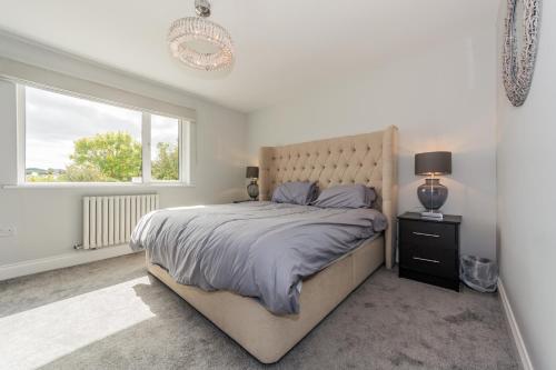 a bedroom with a large bed and a window at Marina views, Kinsale, Hosted by Exquisite holiday homes, sleeps 20 in Kinsale