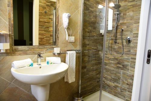 a bathroom with a sink and a shower at Armonia Rooms in Termoli