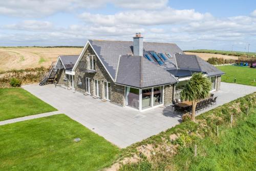 an aerial view of a house with a patio at Ocean View,Kinsale, Hosted by Exquisite holiday homes, sleeps 22 in Kinsale