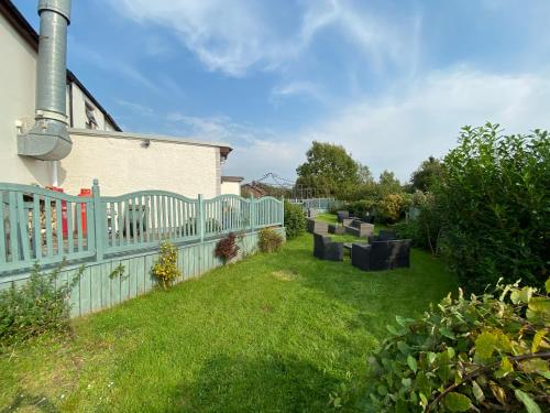 a garden with a fence and a yard with green grass at Flambards Hotel in Cardigan