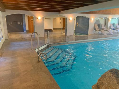 a large swimming pool in a hotel room at Monami Apartments Klosters, Apartment 638 Silvretta Parkhotel in Klosters