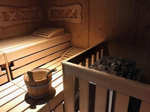a room with two beds and a bucket on a balcony at Monami Apartments Klosters, Apartment 638 Silvretta Parkhotel in Klosters
