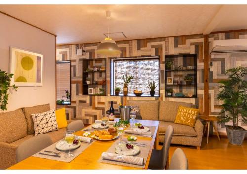 a living room with a table and a couch at Residential Hotel 183 Naha in Naha