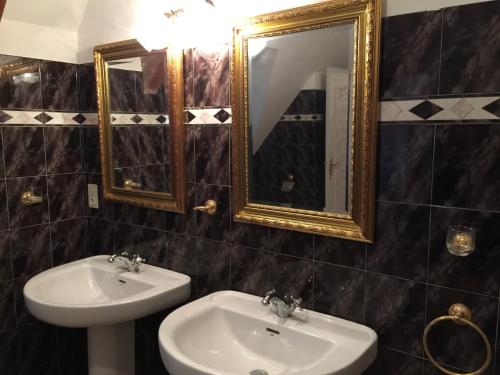 een badkamer met een wastafel en een spiegel bij Le Belvédère in Thiviers