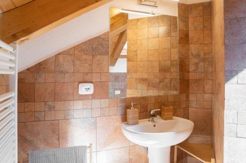 a bathroom with a sink and a mirror at Mansarda Villa Adele in Santo Stefano dʼAveto