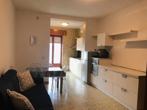 a kitchen with a couch and a table in a room at Porto di Ponza - Immobilevante in Ponza