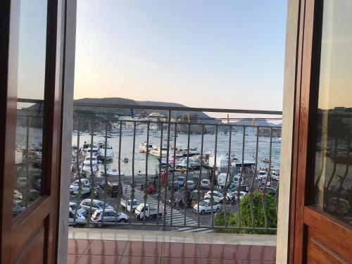 a view of a parking lot with cars in a harbor at Porto di Ponza - Immobilevante in Ponza
