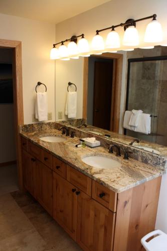 a bathroom with two sinks and a large mirror at Woods Manor #302-A - Close to Main Street - Access to Indoor Hot Tub and Shuttle in Breckenridge
