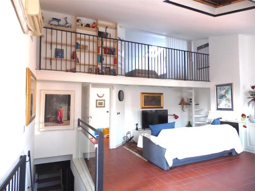 a bedroom with a white bed and a balcony at casa silvia in Lucca