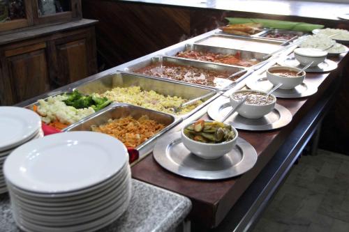 a buffet line with plates and bowls of food at Hotel Universo in Guadalajara