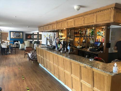 a bar in a pub with a lot of alcohol at The Elm Tree Inn in Wisbech