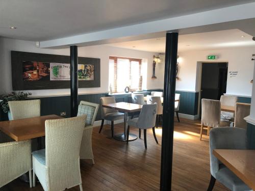 a restaurant with tables and chairs and a dining room at The Elm Tree Inn in Wisbech