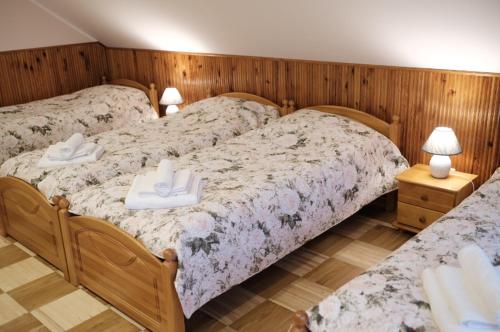 a bedroom with two beds with towels on them at Alma B&B in Kalvarija