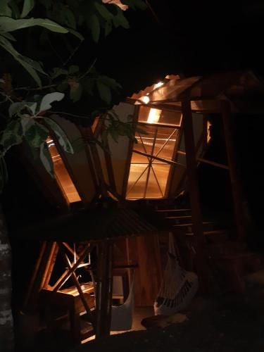 a lantern sitting next to a chair in the dark at Kasaguadua - RESERVA NATURAL in Salento