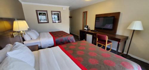 A bed or beds in a room at Grand Forks Inn