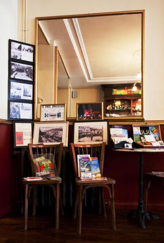 a room with two chairs and a mirror at Hostellerie du Coq d'Or in Jonzac