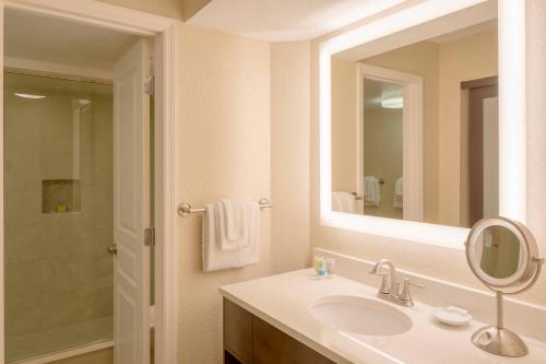 a bathroom with a sink and a mirror at Bluegreen Vacations Casa Del Mar in Ormond Beach
