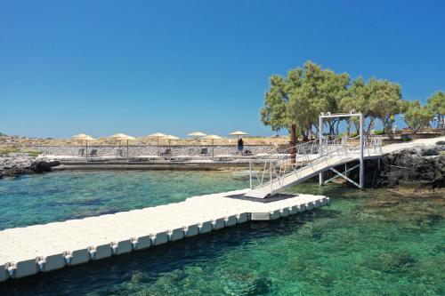 a bridge over a body of water at Kavos Hotel & Suites in Stavros