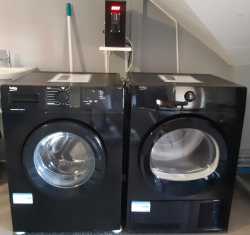 a washing machine and a dryer in a room at MyHome Basel 3A44 in Saint-Louis