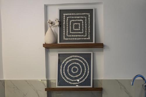 a shelf with two framed pictures on a wall at Agata Hotel Boutique & Spa in Mexico City
