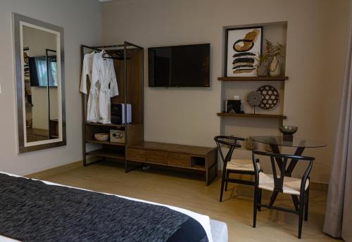 a bedroom with a bed and a table and a mirror at Agata Hotel Boutique & Spa in Mexico City