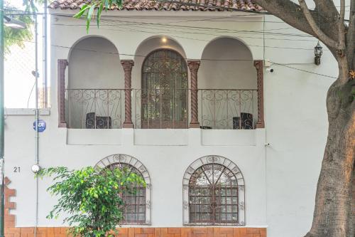 a white building with arched windows on it at Agata Hotel Boutique & Spa in Mexico City