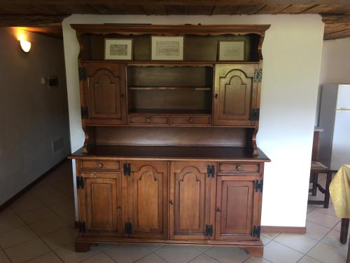 a large wooden entertainment center in a room at Agriturismo Il Balcone sulla Valle in Bedero Valcuvia