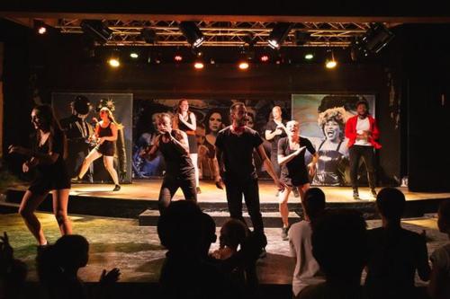 a group of people dancing on a stage at Bungalow in Canet-en-Roussillon