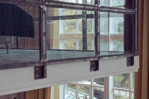 a glass window with a view of a building at Nääs Fabriker Hotell & Restaurang in Tollered