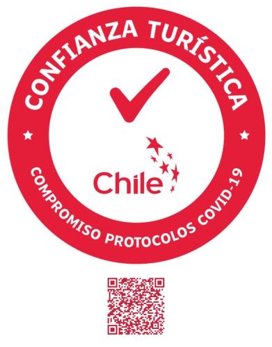 a red circle with the words colombia turkish chile logo at Cabañas y Casa Kauken in Puerto Natales