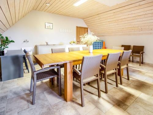 a dining room with a wooden table and chairs at home in a rural setting with a wonderfully garden in Beselare