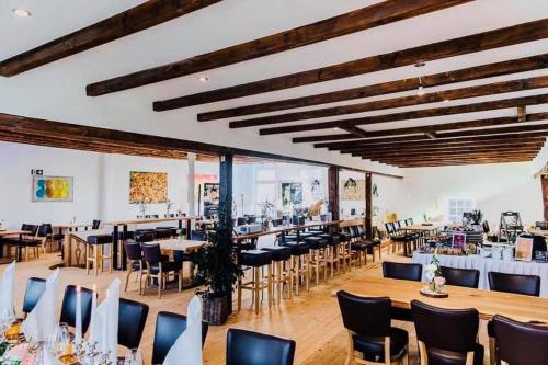 a banquet hall with tables and chairs in a building at Haus Mees Apartments in Wuppertal