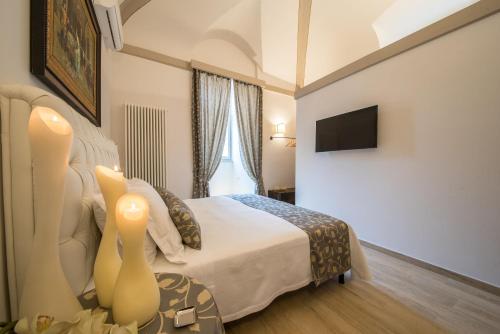 a hotel room with a bed and a television at Suite Assisi in Assisi
