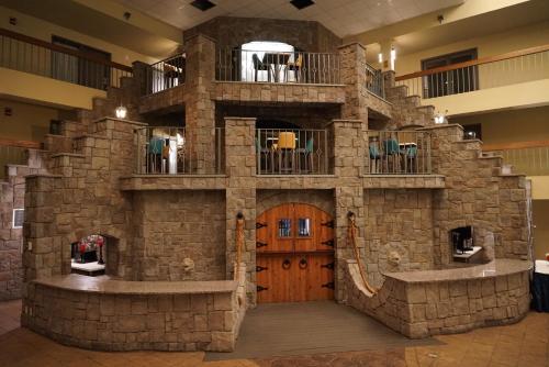 a large stone building with a wooden door at Baymont by Wyndham Shakopee in Shakopee
