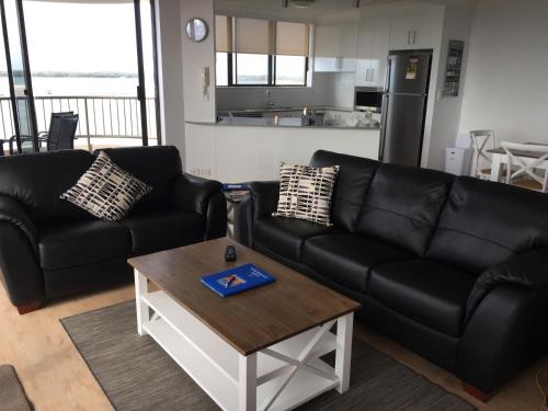 a living room filled with furniture and a coffee table at Broadwater Shores Waterfront Apartments in Gold Coast