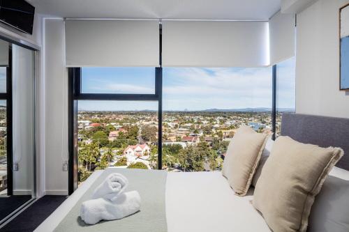 a bedroom with a white bed and a large window at First Light Mooloolaba, Ascend Hotel Collection in Mooloolaba