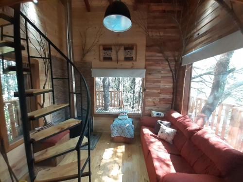 a living room of a log cabin with a couch at Domos Entre Bosques in Malalcahuello