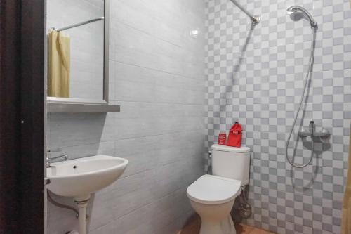 a bathroom with a sink and a toilet and a shower at RedDoorz @ Bukit Dieng 2 in Malang